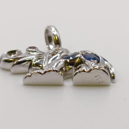 527 - An 18ct white gold, diamond and sapphire pendant, in the form of an elephant...