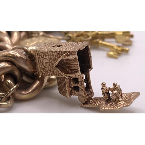 543 - A 9ct gold bracelet, having a heart shaped padlock clasp, with assorted gold and yellow coloured met... 