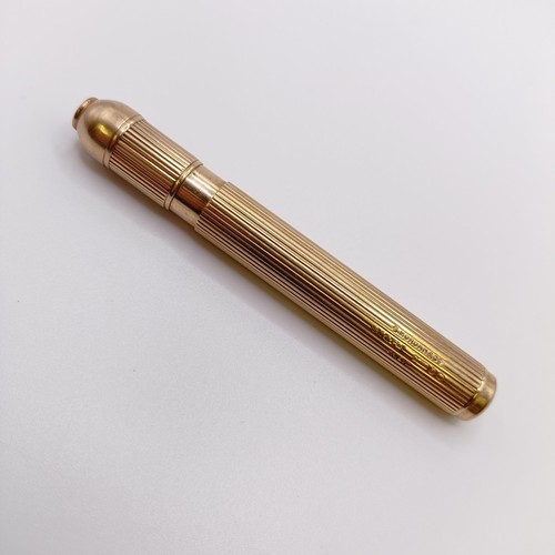 546 - A 9ct gold cased pencil, all in 29.9 g...