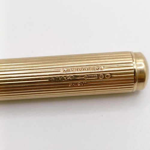 546 - A 9ct gold cased pencil, all in 29.9 g...