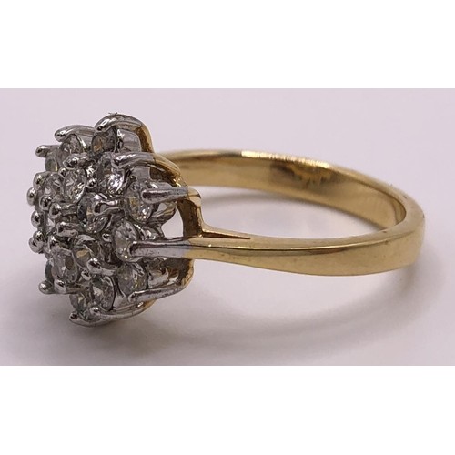 554 - A yellow metal and white stone cluster ring, ring size R