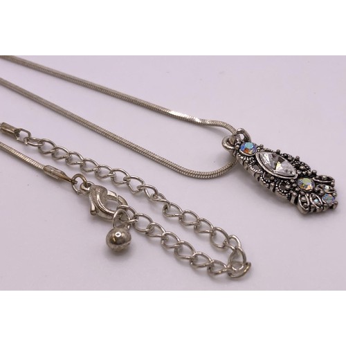 566 - A silver coloured metal pendant on a chain, and matching earrings (3)