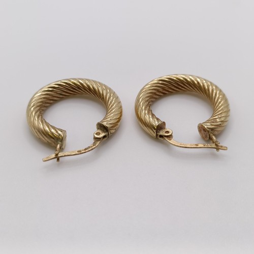 570 - A pair of 9ct gold hoop earrings, and another pair, 4.2 g