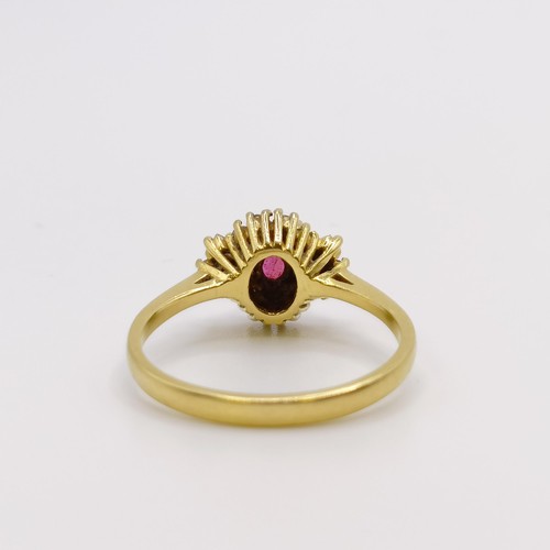 579 - An 18ct gold, diamond and ruby ring, ring size N