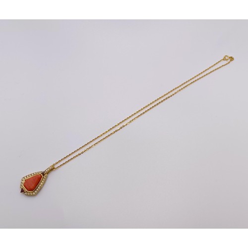 580 - An 18ct gold, coral and diamond pendant, on an 18ct gold chain