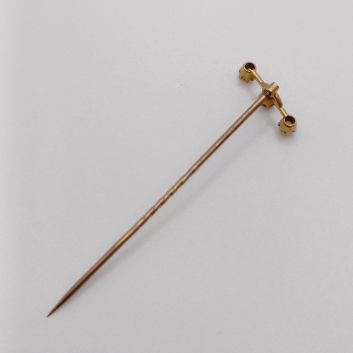 590 - A stick pin, inset with a red coloured stone and seed pearls