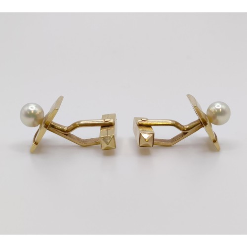 593 - A pair of 14ct gold and Mikimoto pearl cufflinks