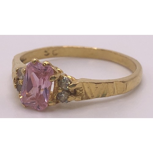 595 - An 18ct gold and pink sapphire ring, ring size J