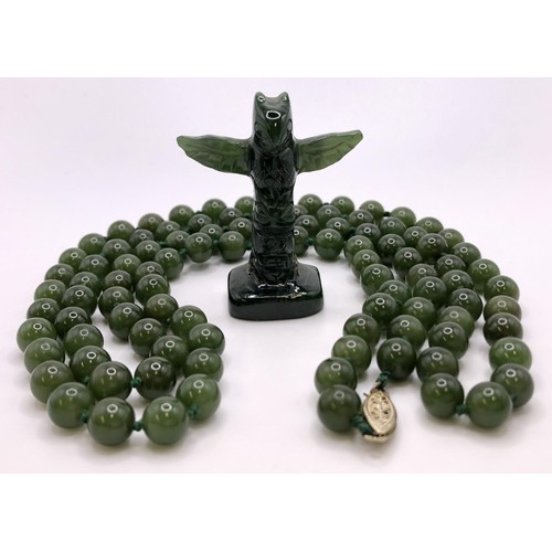 596 - A jade bead necklace, and a jade carved totem pole, (2)