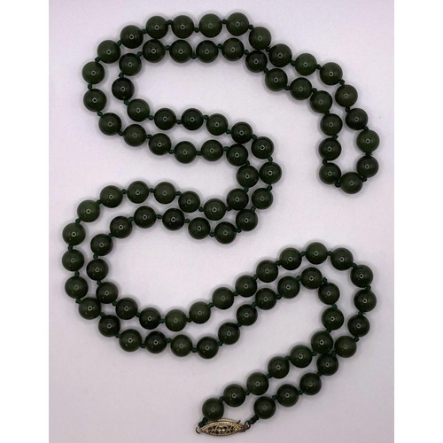 596 - A jade bead necklace, and a jade carved totem pole, (2)