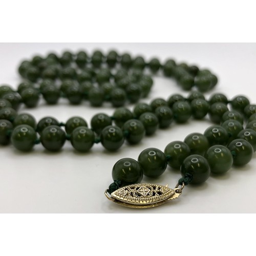 596 - A jade bead necklace, and a jade carved totem pole, (2)