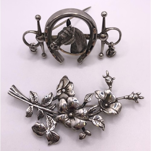 603 - A silver brooch, in the form of a horse head within a horseshoe and a bit, and a floral silver brooc... 