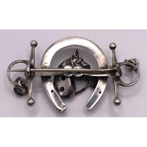 603 - A silver brooch, in the form of a horse head within a horseshoe and a bit, and a floral silver brooc... 