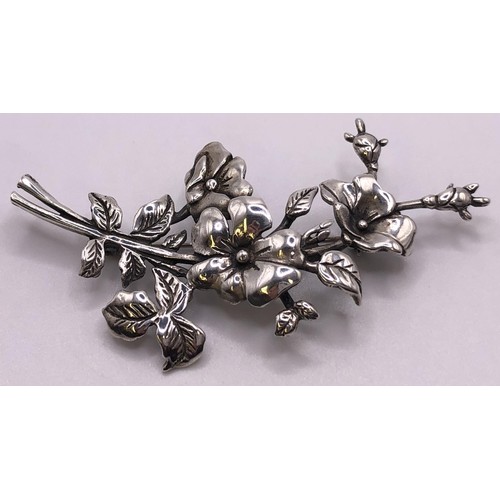 603 - A silver brooch, in the form of a horse head within a horseshoe and a bit, and a floral silver brooc... 