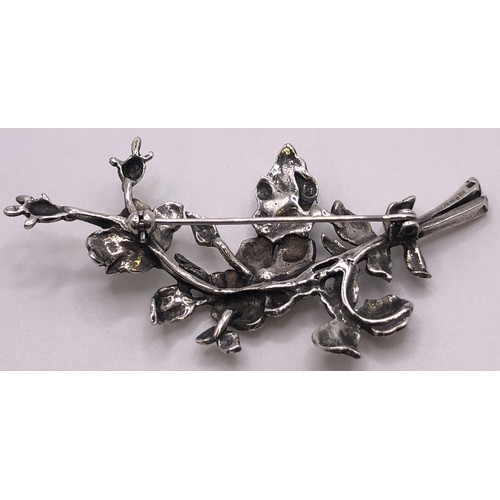 603 - A silver brooch, in the form of a horse head within a horseshoe and a bit, and a floral silver brooc... 