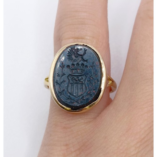 604 - An 18ct gold, diamond and bloodstone intaglio ring, carved a crest, ring size F