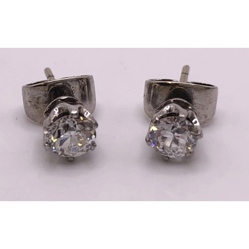 608 - A pair of diamond solitaire stud earrings