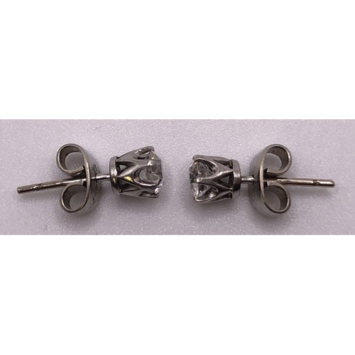 608 - A pair of diamond solitaire stud earrings