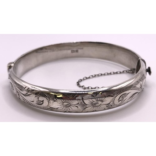 611 - A silver bracelet, with attached locket, two lockets, a silver bangle, other silver and silver colou... 