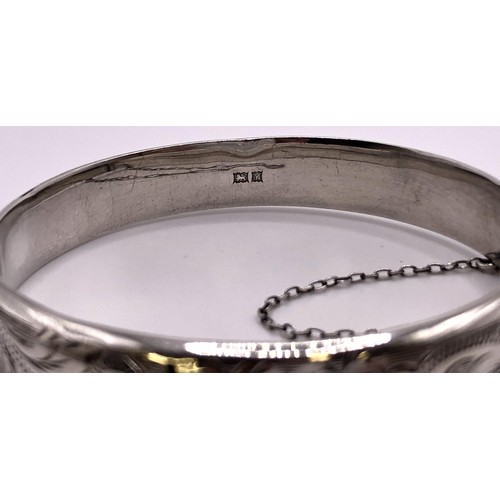 611 - A silver bracelet, with attached locket, two lockets, a silver bangle, other silver and silver colou... 