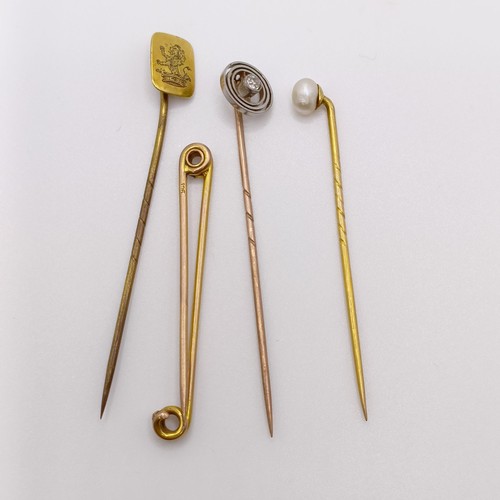 612 - A 9ct gold and diamond stick pin, a bar brooch, and two stick pins (4)