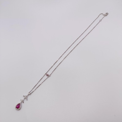 632 - An 18ct white gold, ruby and diamond pendant, on an 18ct gold chain