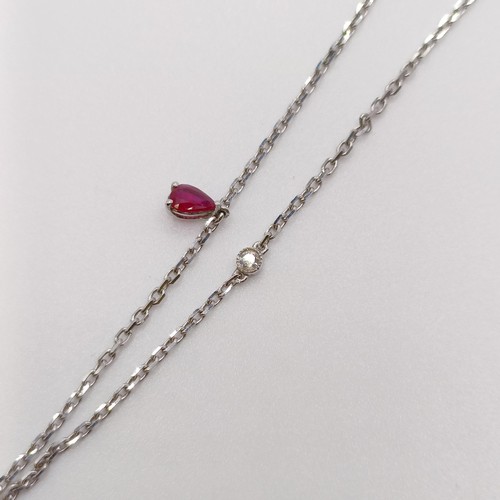 632 - An 18ct white gold, ruby and diamond pendant, on an 18ct gold chain