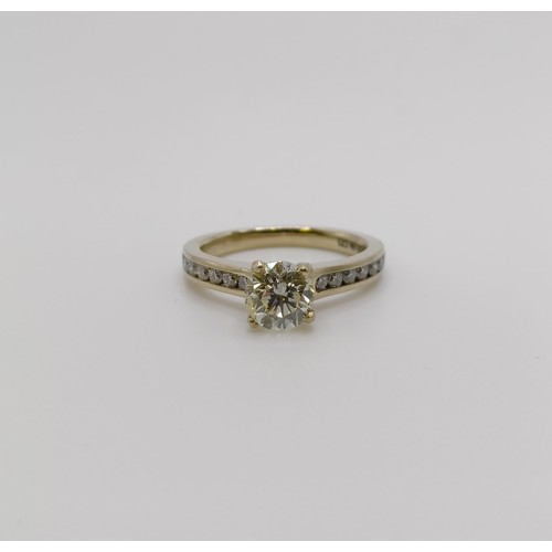 639 - An 18ct gold and diamond solitaire ring, approx. 1.1ct, with diamond set shoulders, ring size I