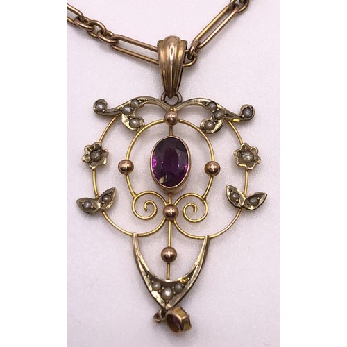 640 - An early 20th century, yellow metal, purple stone and seed pearl pendant, on a 9ct gold chain, all i... 