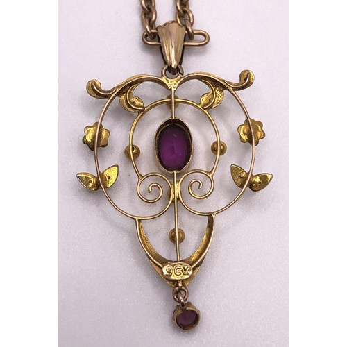 640 - An early 20th century, yellow metal, purple stone and seed pearl pendant, on a 9ct gold chain, all i... 