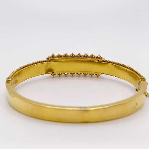 647 - A late 19th/early 20th century 15ct gold, turquoise and seed pearl bangle, 15.8 g all in