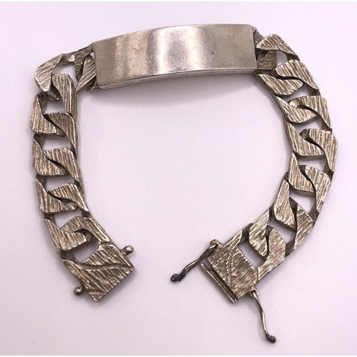 648 - A textured silver identity bracelet, 64.5 g