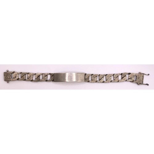 648 - A textured silver identity bracelet, 64.5 g