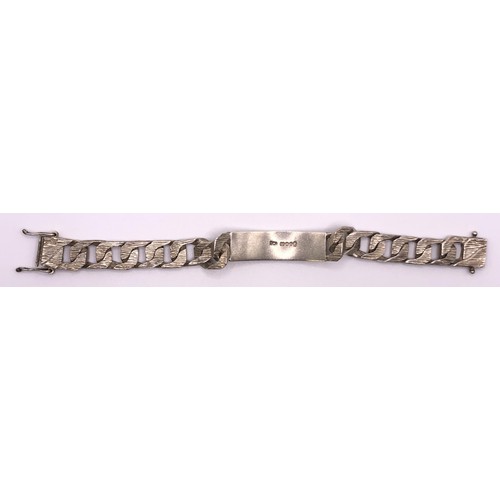 648 - A textured silver identity bracelet, 64.5 g