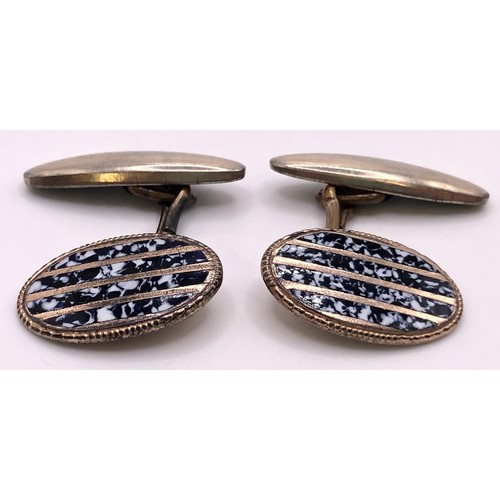 663 - A pair of gold plated and enamel oval cufflinks