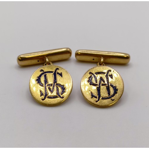 664 - A pair of 18ct gold and blue enamel cufflinks, monogrammed WS, all in 10.9 g