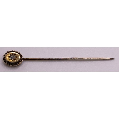 666 - An early 20th century 15ct gold and diamond stick pin, cased