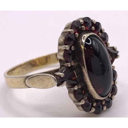 667 - A 9ct gold and cabochon garnet cluster ring, ring size L, and a similar pair of earrings (3)