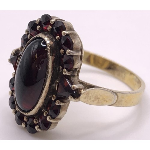 667 - A 9ct gold and cabochon garnet cluster ring, ring size L, and a similar pair of earrings (3)