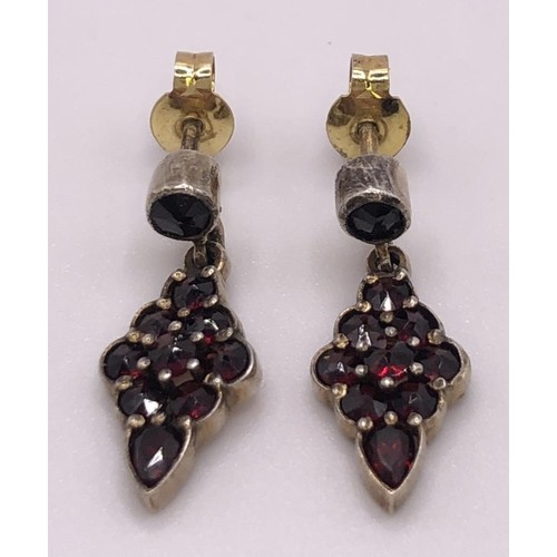 667 - A 9ct gold and cabochon garnet cluster ring, ring size L, and a similar pair of earrings (3)