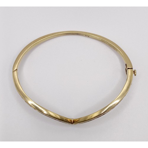 669 - A yellow metal and diamond bangle, diamond weight approx. 3ct