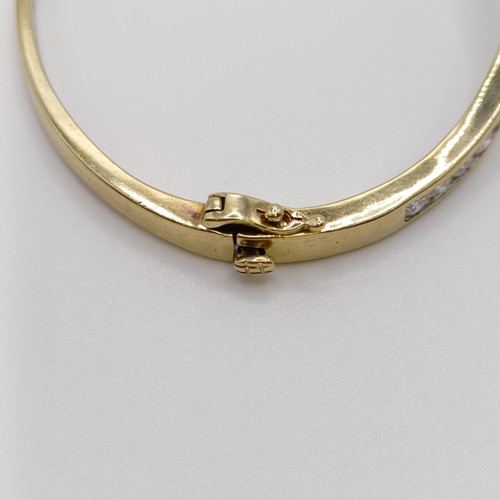 669 - A yellow metal and diamond bangle, diamond weight approx. 3ct