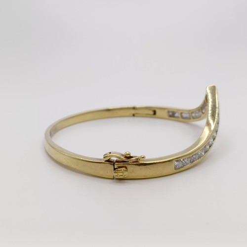 669 - A yellow metal and diamond bangle, diamond weight approx. 3ct