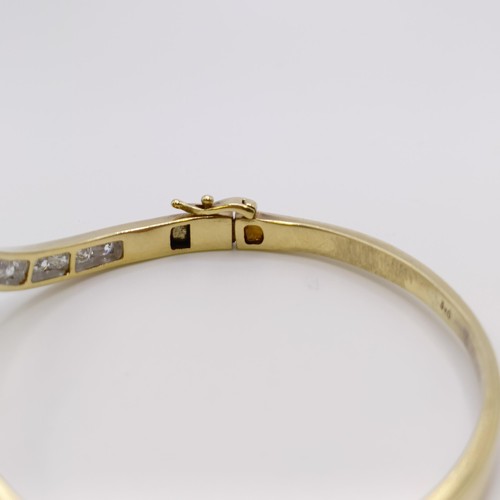 669 - A yellow metal and diamond bangle, diamond weight approx. 3ct