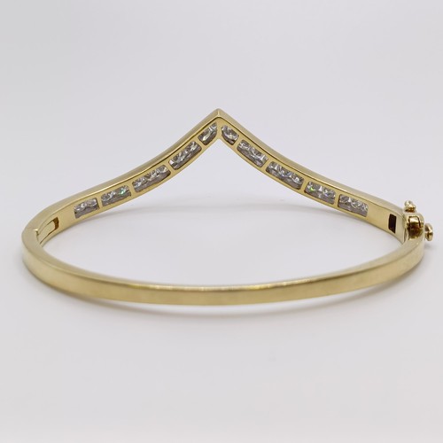 669 - A yellow metal and diamond bangle, diamond weight approx. 3ct