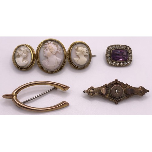 671 - A 9ct gold brooch, in the form of a wishbone, with a stainless steel pin, all in 1.5 g, a cameo broo... 