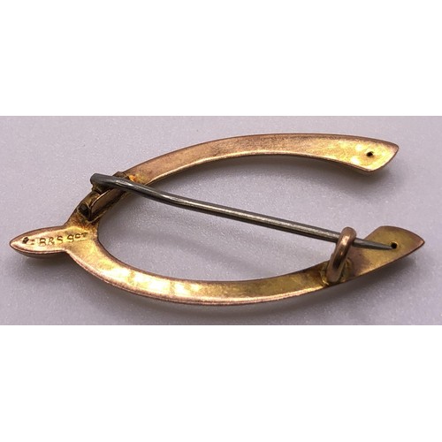 671 - A 9ct gold brooch, in the form of a wishbone, with a stainless steel pin, all in 1.5 g, a cameo broo... 