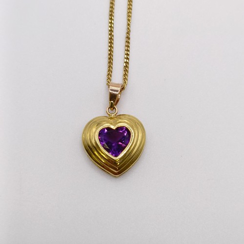 672 - An 18ct gold and amethyst pendant, on an 18ct gold chain