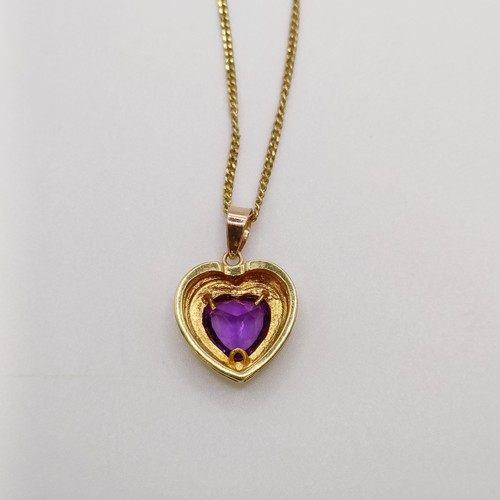 672 - An 18ct gold and amethyst pendant, on an 18ct gold chain