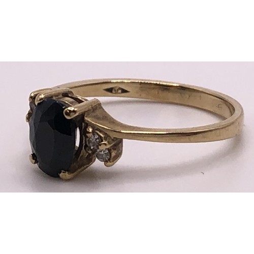 674 - A 9ct gold, sapphire and diamond ring, ring size O